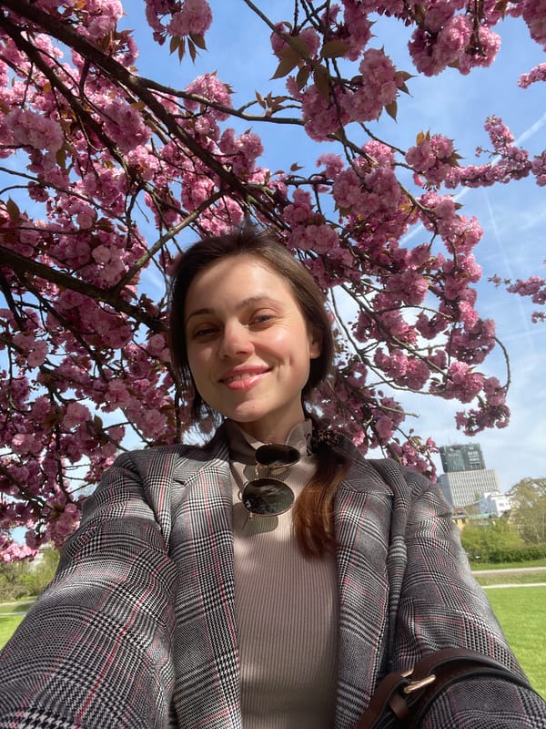 Woman takes selfies during spring afternoon in Ljubljana park
