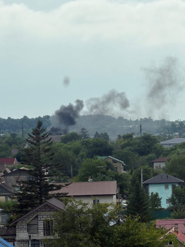 Fire smoke over Artyom neighborhood while a cat sleeps peacefully