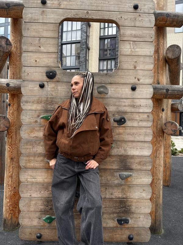Woman enjoys playground equipment during morning hours in urban setting