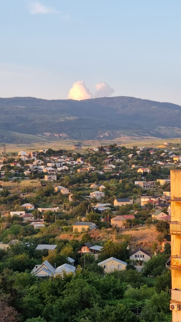 Tbilisi residential neighborhood at golden hour, Soviet blocks and all