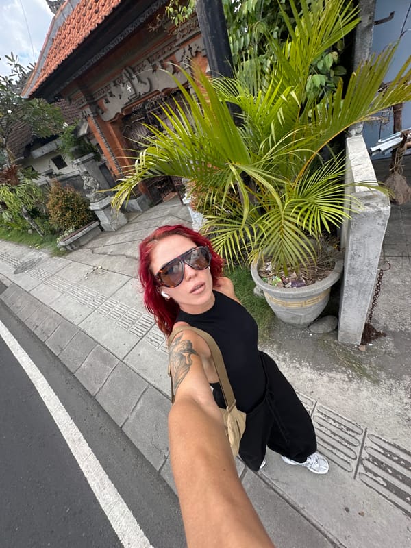 Woman takes selfie on North Kuta street early morning