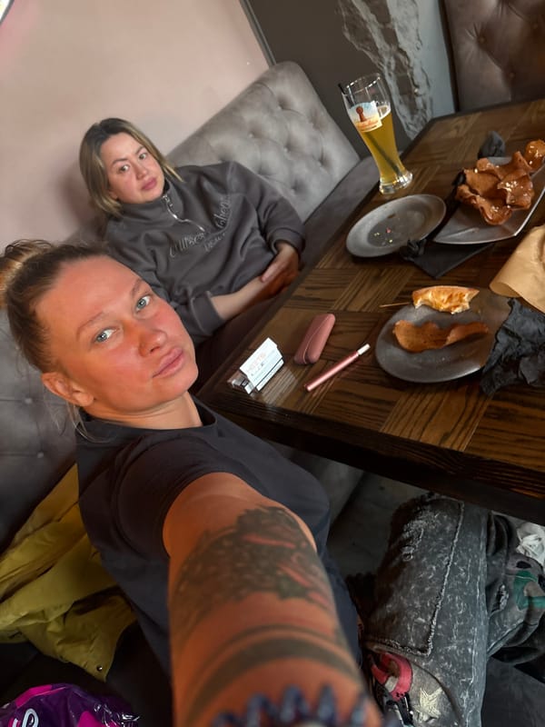 Friends share drinks and pizza at Perm establishment