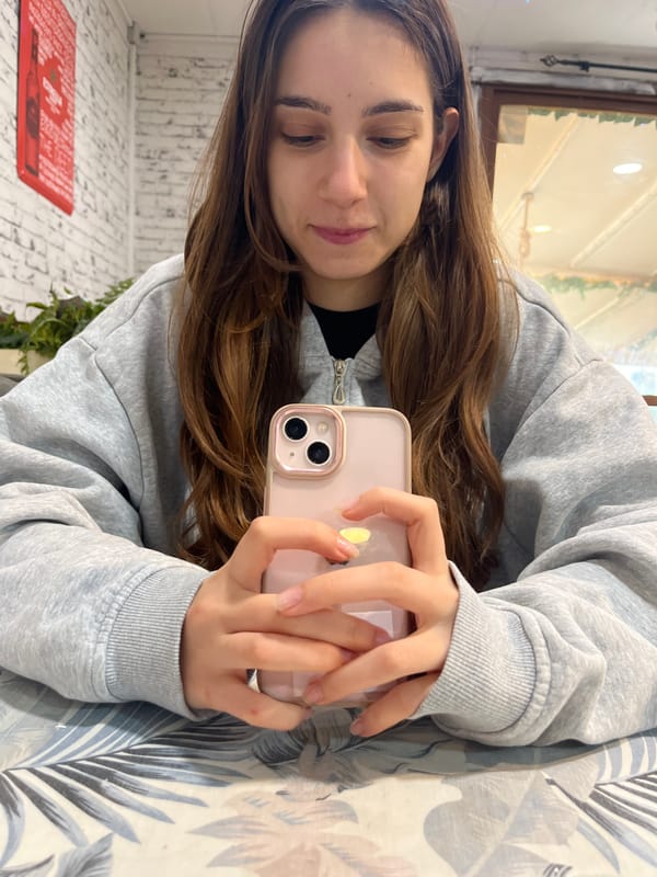 Woman with pink iPhone photographed indoors in Sofia