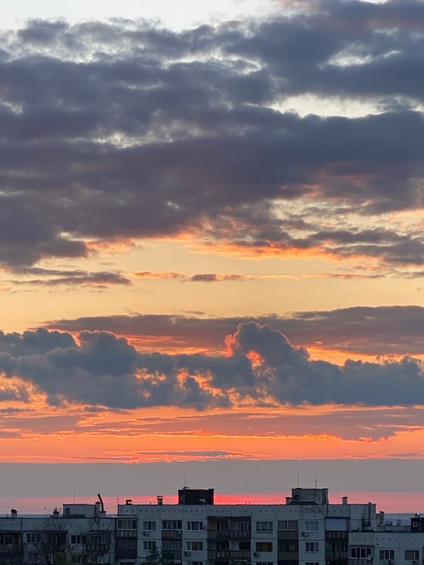 Person performs rooftop handstand during sunset in Pleven, Bulgaria