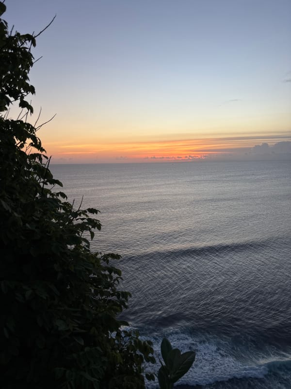 Sunset gathering observed on Pecatu cliffs overlooking ocean