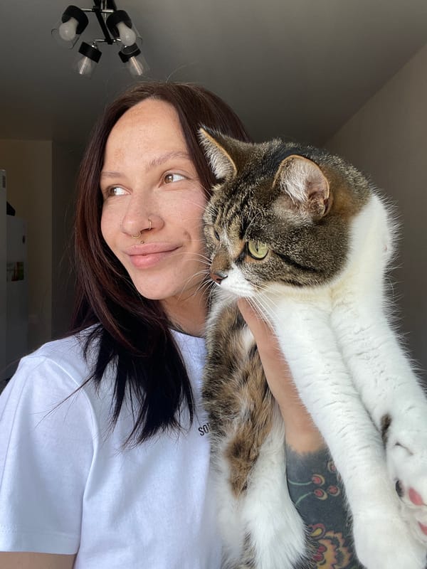Woman holds cat in Izhevsk home