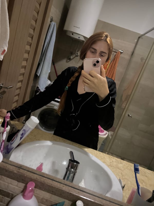Woman documents evening routine amid cluttered kitchen in Budva apartment