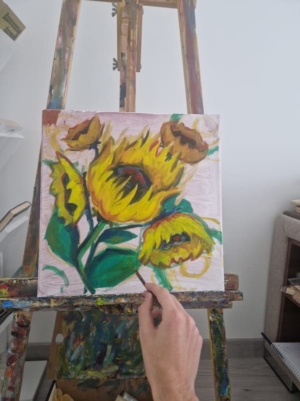 Artist paints sunflower canvas during morning session