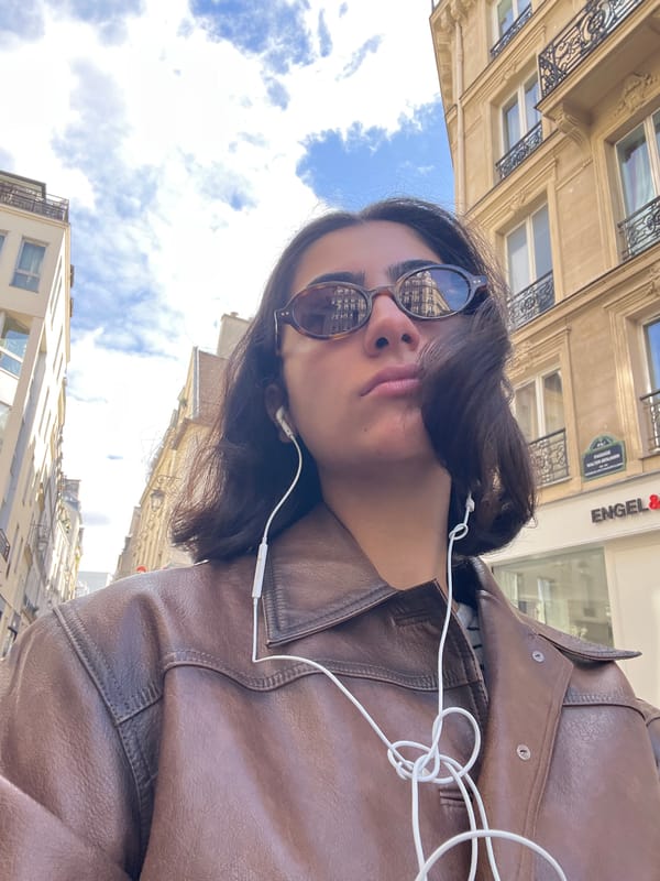 Person photographed looking skyward in Paris daylight