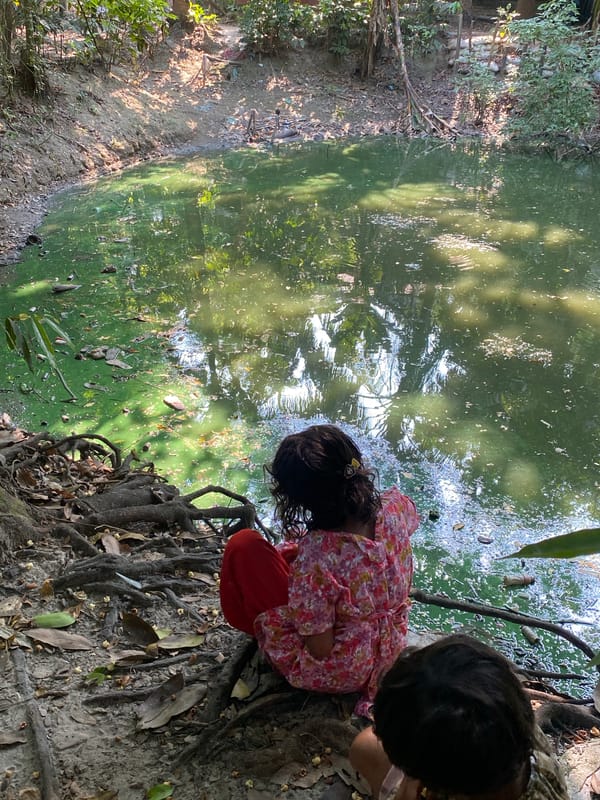 Children playing outdoors in Bangladesh community morning scenes