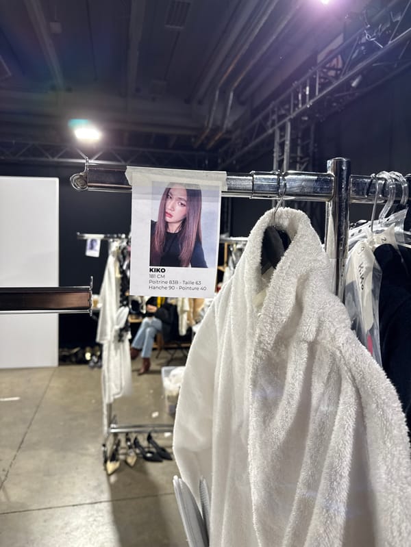 Fashion show staged in Issy-les-Moulineaux with blue-lit runway