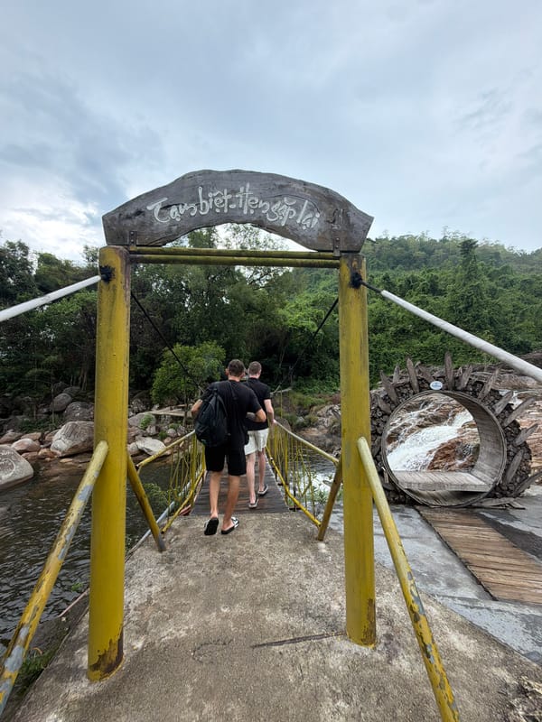 Two men explore Yang Bay Waterfall Park in Vietnam