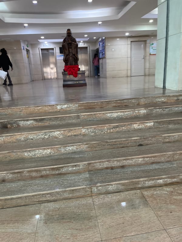 Building lobby with statue and elevators captured in Changchun