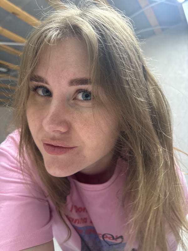 Woman in pink "I Don't Wanna Hate" shirt photographed in Gornyi