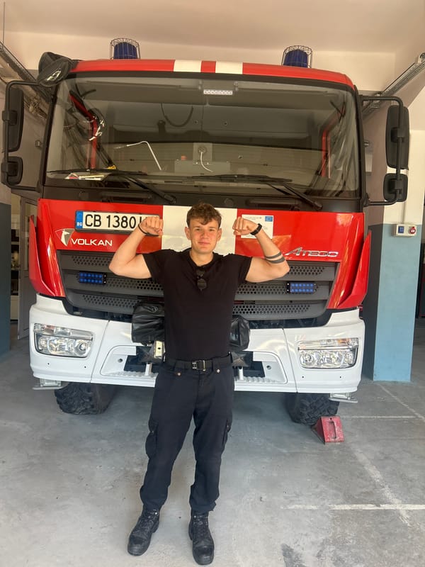 Man poses with fire truck at Sofia station