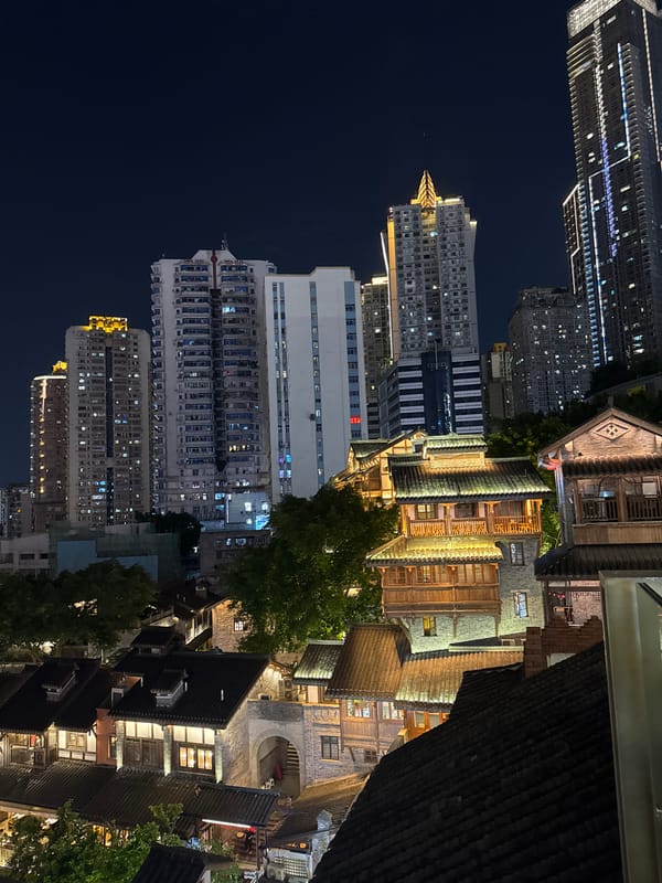 Hongyadong's traditional architecture glows against Chongqing's modern skyline