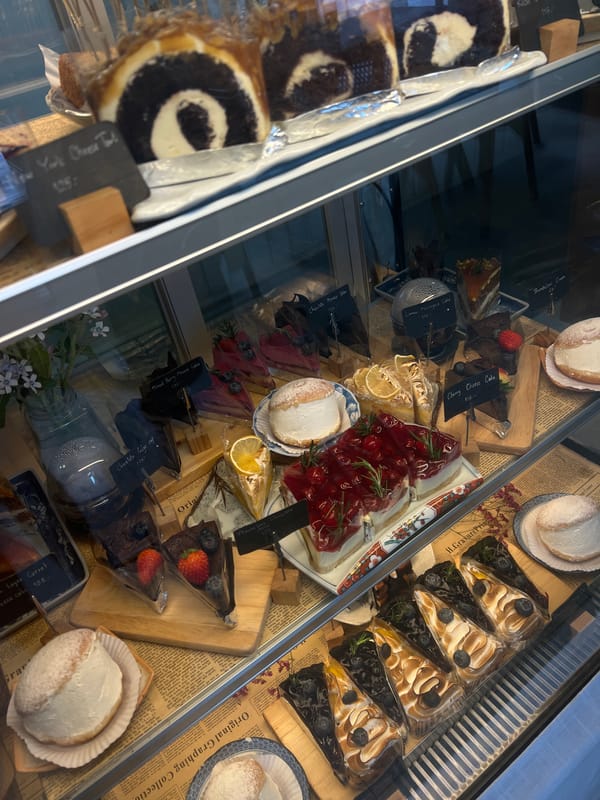 Bakery display case spotted with assorted desserts and pastries
