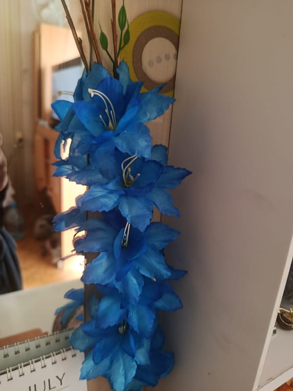 Decorative flowers and colorful abstract wall art, indoors.