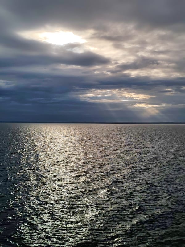 Dark storm clouds gather over water in Kuzaranda, Russia