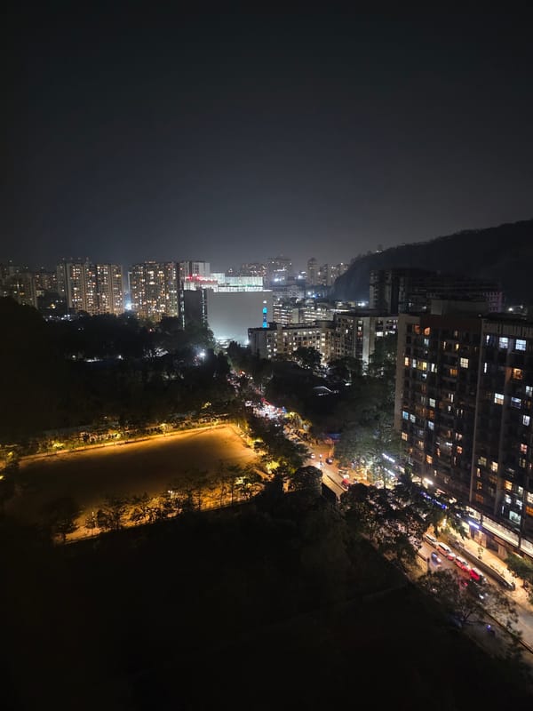 Aerial nighttime view captures Mumbai's illuminated high-rise skyline