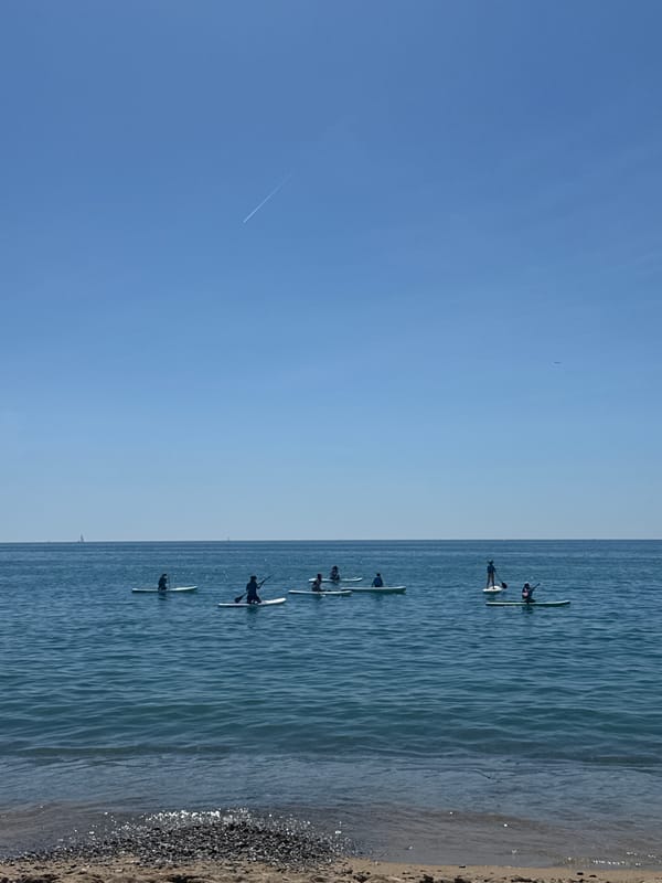 Barcelona residents enjoy morning paddleboarding and skateboarding activities