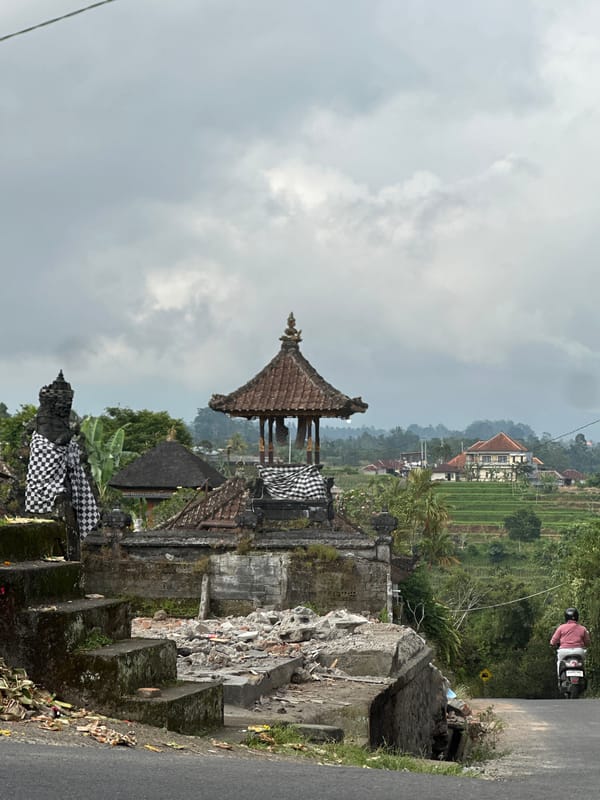 Traditional Balinese temple photographed under cloudy skies in Baturiti