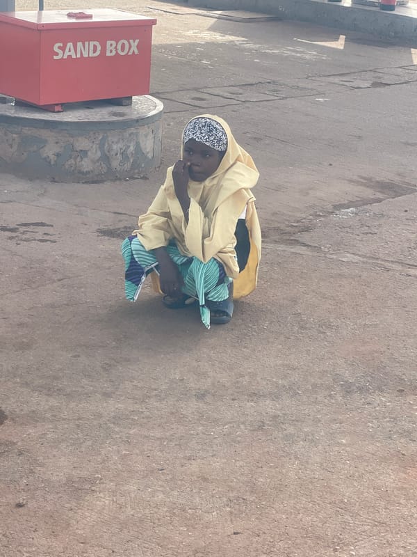 Child plays near sandbox container in Jos, Nigeria