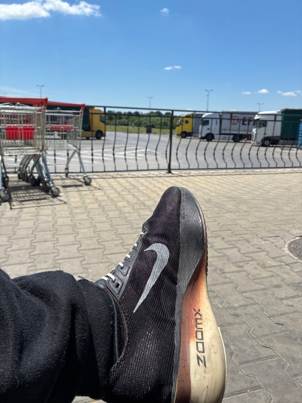 Pedestrian in Nike shoes walks urban pathway