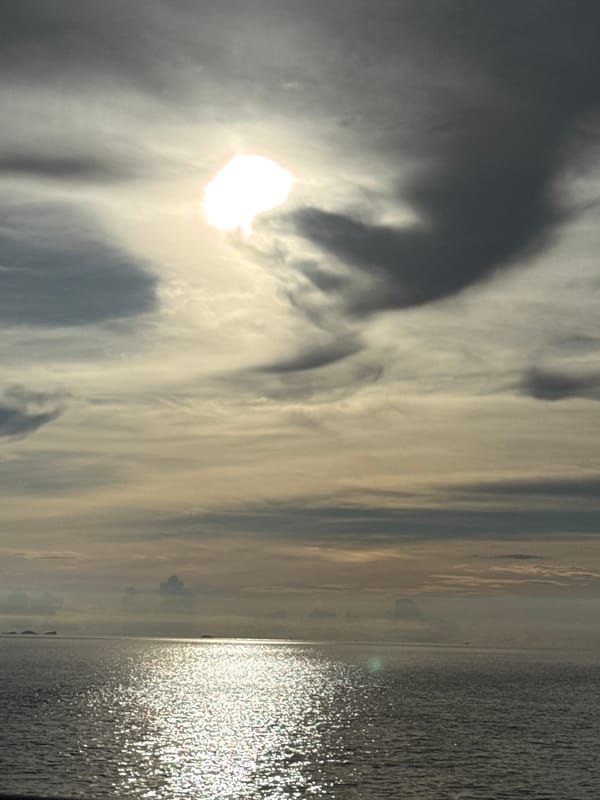 Sun breaks through dramatic clouds over Ko Pha-ngan waters