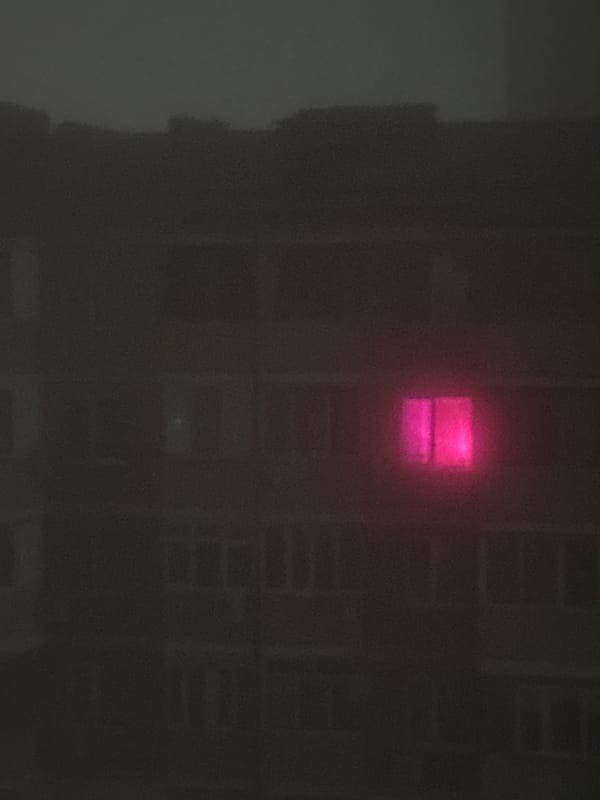 Heavy fog blankets city streets during late evening hours