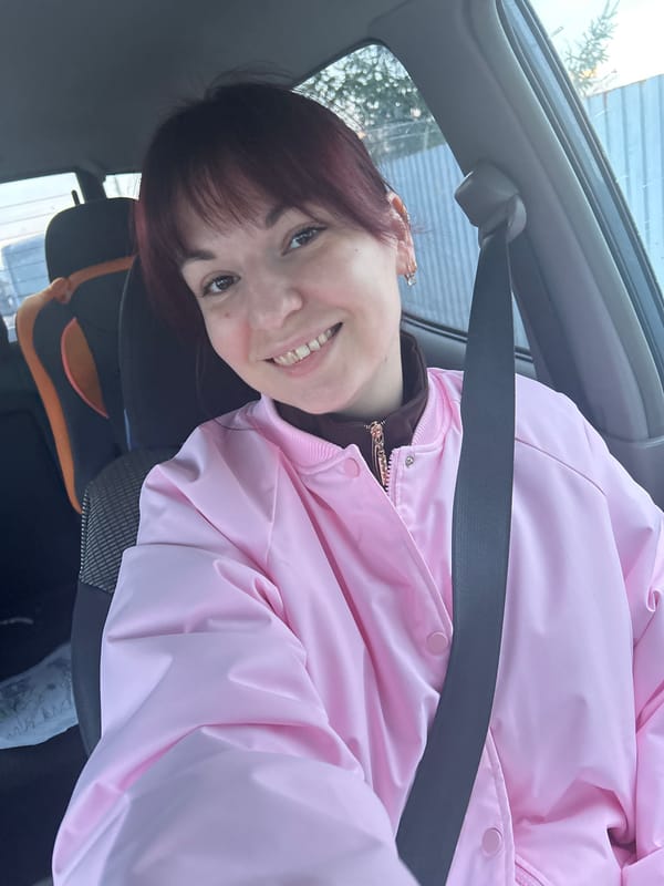 Woman with child car seat in parked vehicle