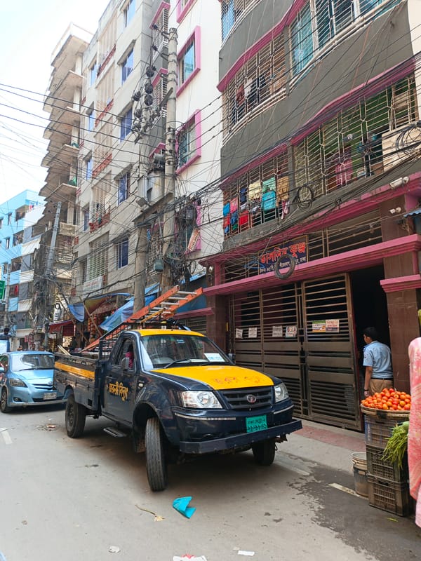 Street vendor with cart observed during morning hours in Dhaka