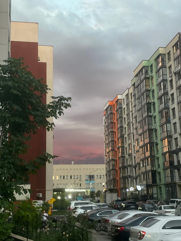 Almaty residential complex at sunset, streets to skyline
