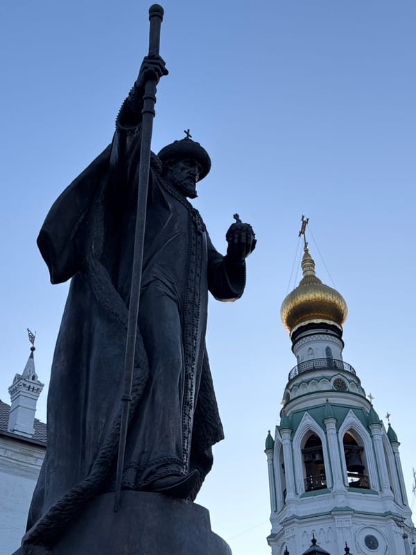 Tourist documents historic Vologda landmarks during evening walk