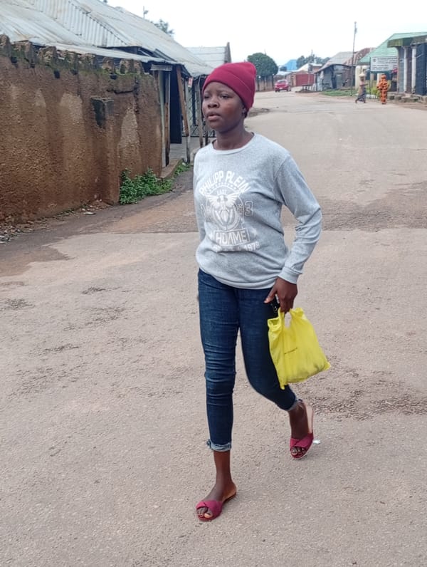 Morning street life across a Jos neighborhood