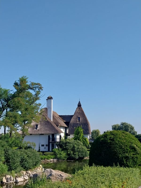 Morning walk through Dnipro's waterfront park and thatched-roof buildings