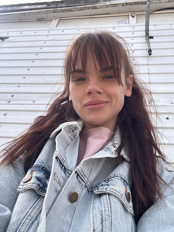 Woman in pink shirt, denim jacket photographed around Rostov-on-Don