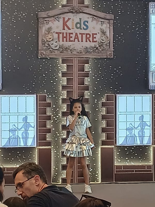 Kids singing competition at a themed stage venue