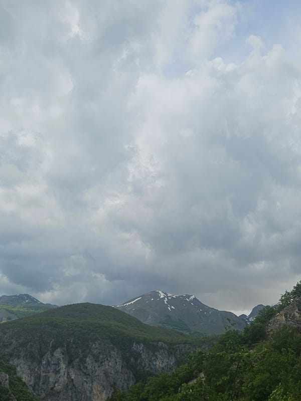 Mountain vistas and Pivsko Lake documented under cloudy skies