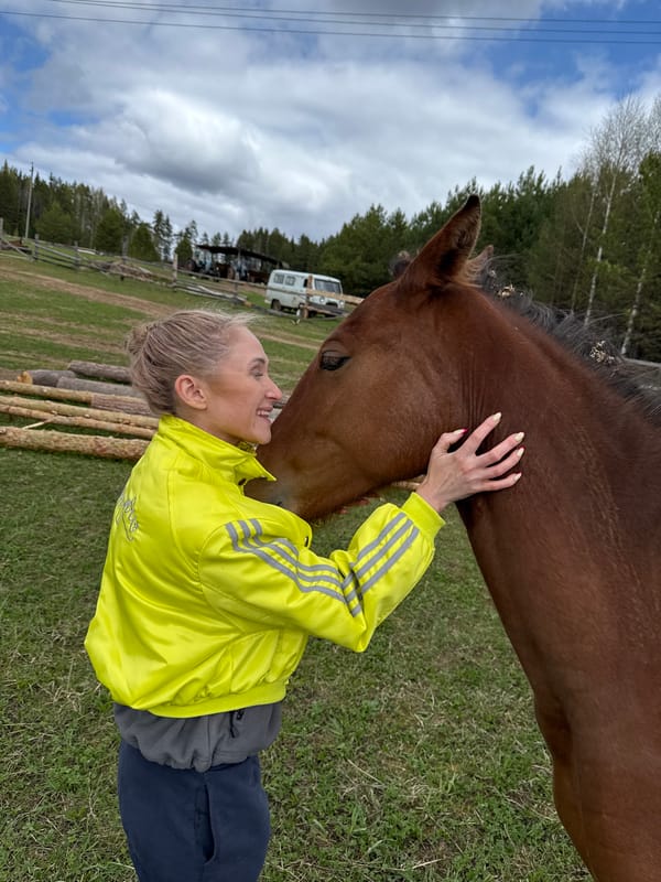 Woman pets horse in Russian field, shares moment