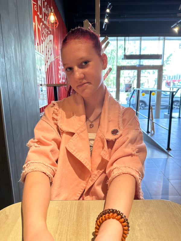 Woman with purple hair sits at table in Saratov