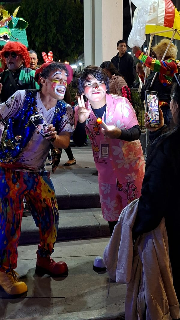 Clowns perform at nighttime street festival in Arequipa, Peru