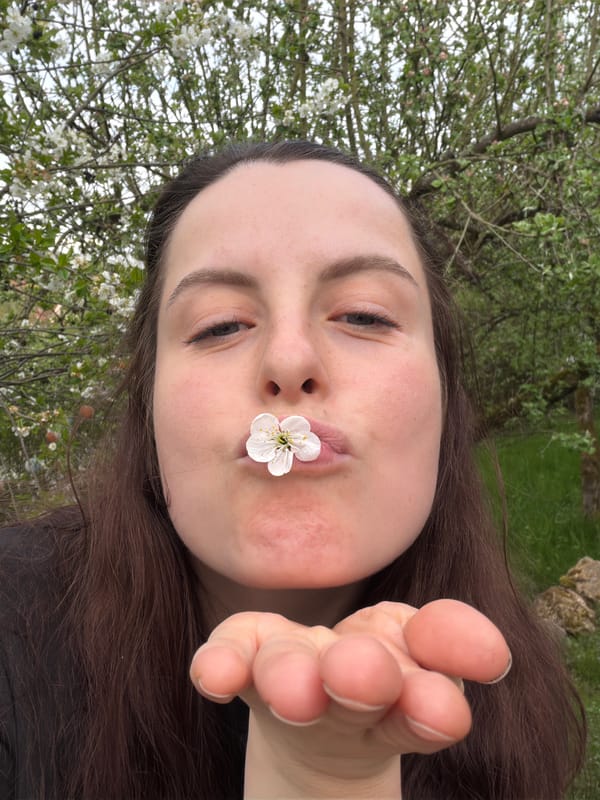 Woman poses with white flower for selfie in Gangloff