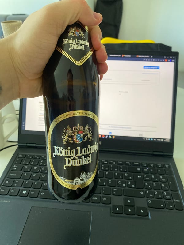Berlin resident enjoys beer while working from home apartment