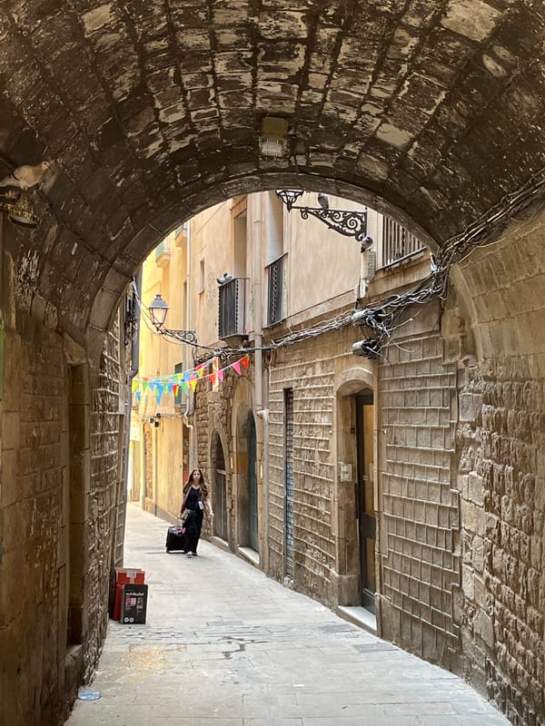 Tourist documents midday stroll through Barcelona's Gothic Quarter