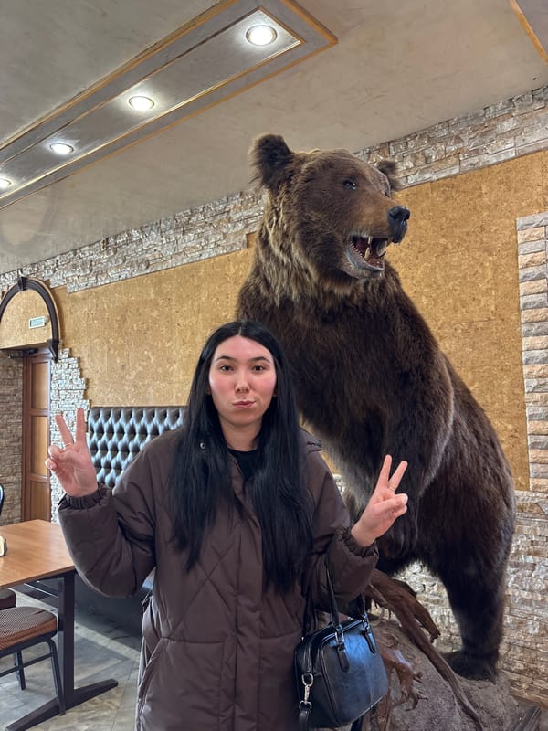 Woman photographed with taxidermied bear, plush toys in Mozhga