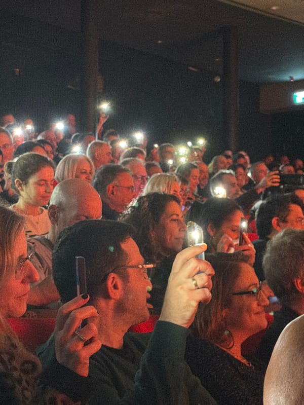 Smartphone flashlights illuminate crowd at Tel Aviv venue