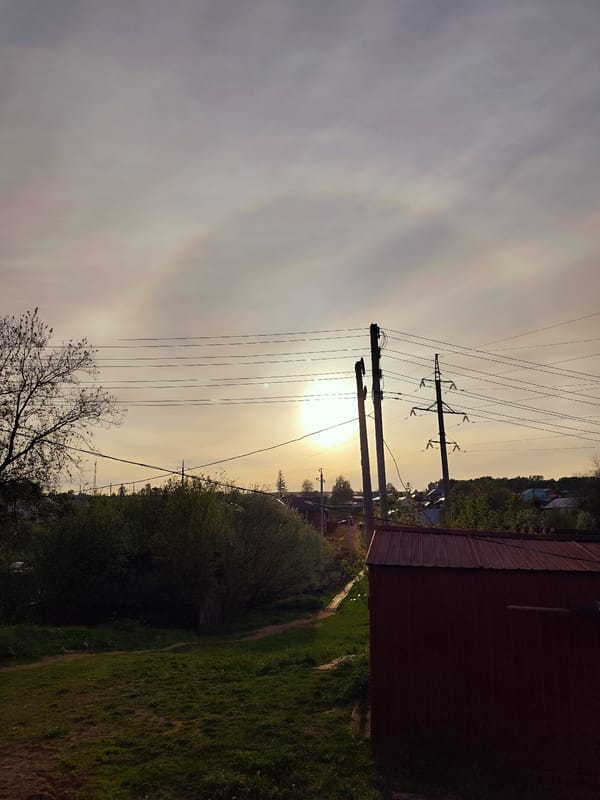 Woman enjoys sunset moments with baby in rural Russia