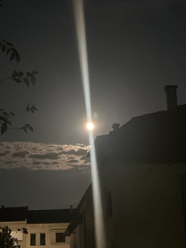 Full moon and light beam over Blagoevgrad on a July night