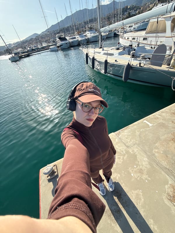 Visitor captures selfies at Sanremo marina on sunny afternoon